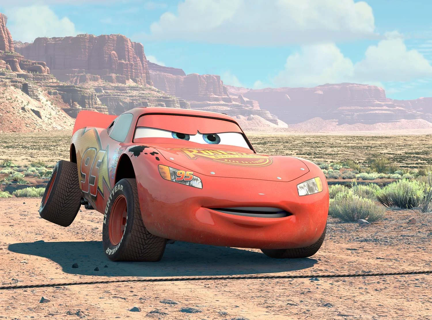 McQueen in the desert, looking confidently at the camera